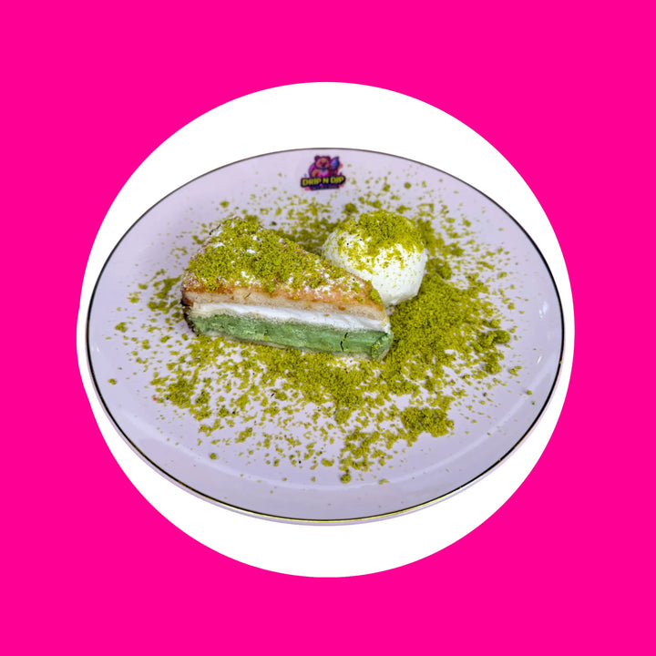 Nutty Pistachio Vanilla Ice Cream Cake — a rich pistachio cake layered with creamy vanilla ice cream, topped with a drizzle of pistachio sauce and crunchy pistachio crumbs